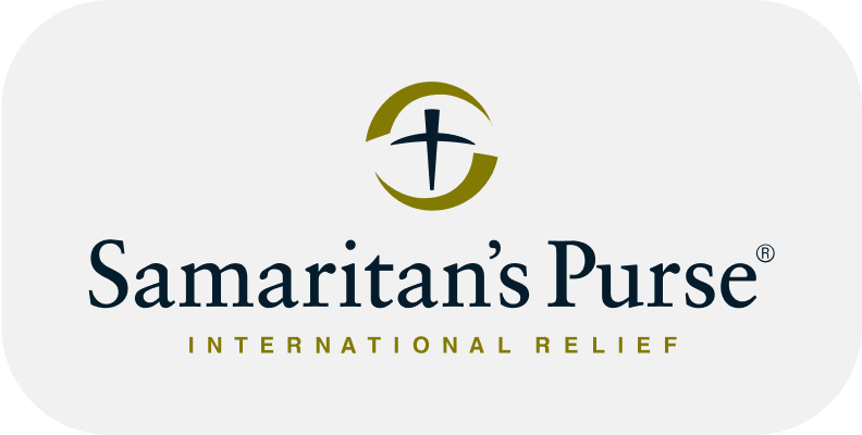 Logo of Samaritan's Purse with a stylized cross icon and text reading "Samaritan's Purse International Relief" on a white background.