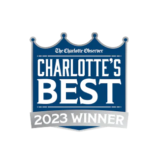 Badge with “The Charlotte Observer” and “Charlotte’s Best 2023 Winner” text, featuring a crown-like design in blue and silver tones.