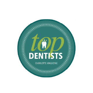 A circular emblem features "Top Dentists" with a tooth icon, awarded by Charlotte Magazine, set against a teal background with a dotted border.