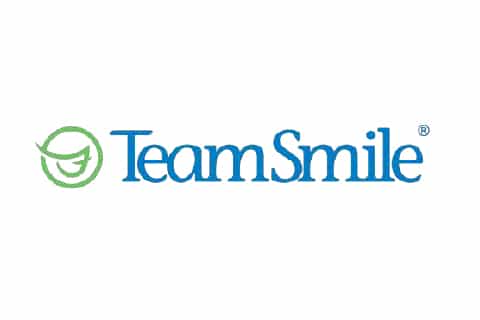 The image features the "TeamSmile" logo with blue text and a green smiling face graphic, emphasizing dental care and community support.