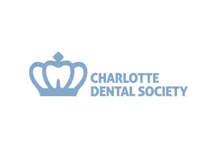 The image shows the logo of Charlotte Dental Society featuring a stylized crown and tooth, with the organization's name in blue text on white background.