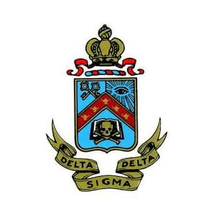 A heraldic crest featuring a crown, keys, an eye, and a skull above a banner with "Delta Delta Sigma" text.