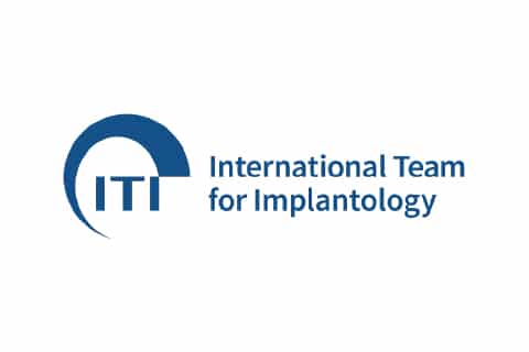 Logo of the International Team for Implantology featuring a blue semi-circle and the acronym "ITI" alongside the organization's full name.