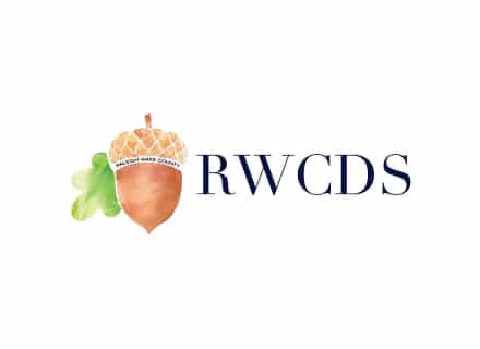 A watercolor acorn with "Raleigh Wake County" text beside the letters "RWCDS" in bold. Simple design with natural elements.