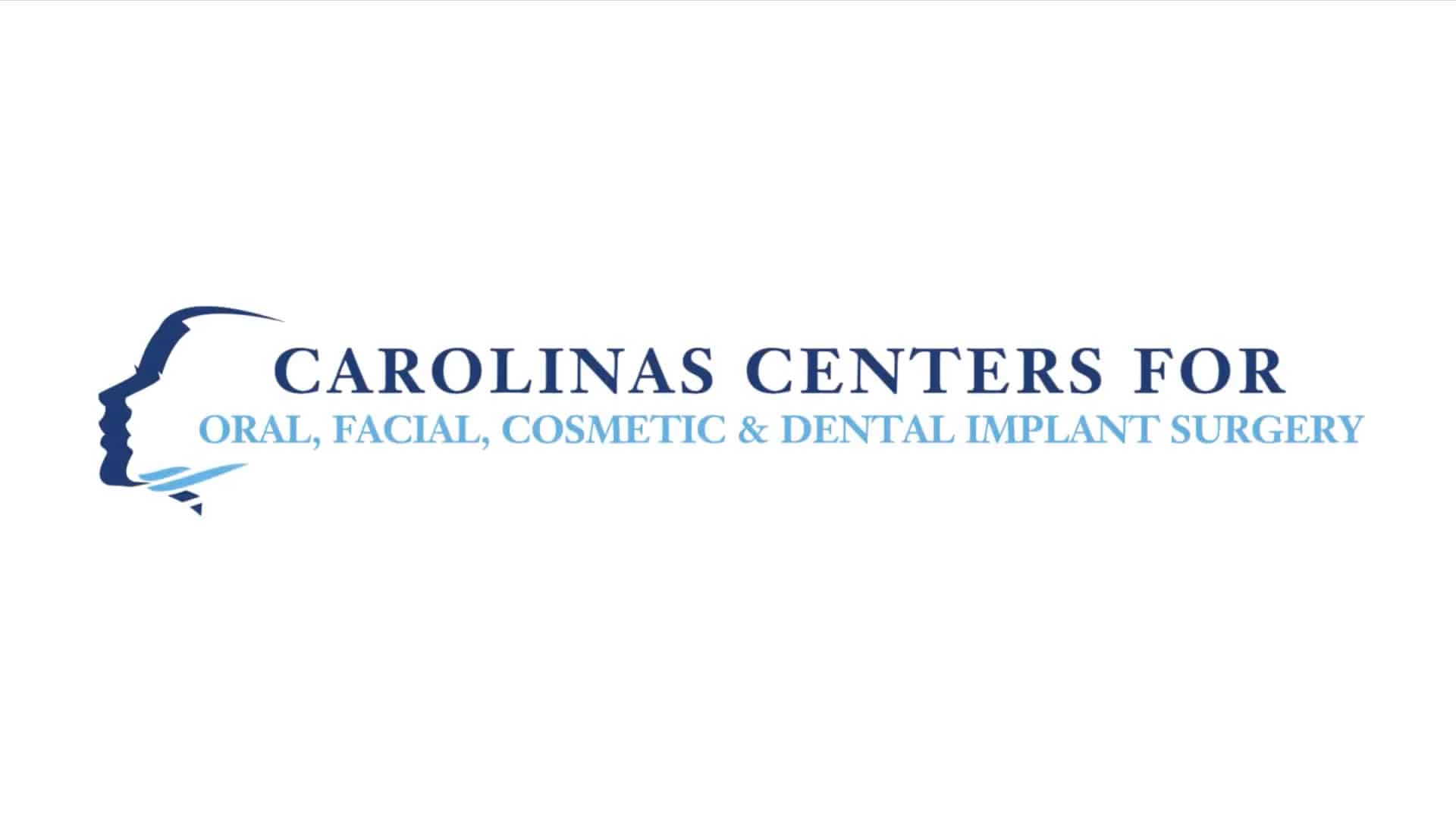 Logo for Carolinas Centers for Oral, Facial, Cosmetic & Dental Implant Surgery, featuring a blue profile silhouette and stylized wave design.