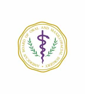 The image features the American Board of Oral and Maxillofacial Surgery emblem, displaying a purple caduceus entwined with green branches within a gold border.