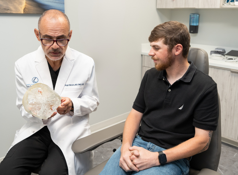 Dr. Moreira with a patient discussing surgical TMJ treatments in Raleigh, NC