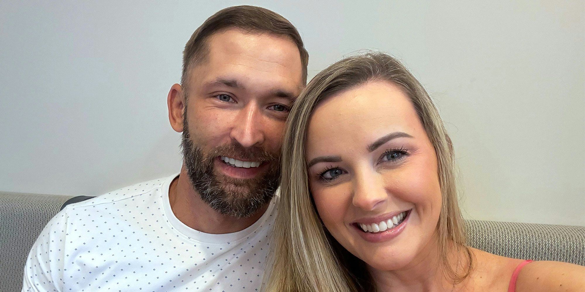 David and wife taking a selfie to show off new full mouth dental implants from Envision in Charlotte