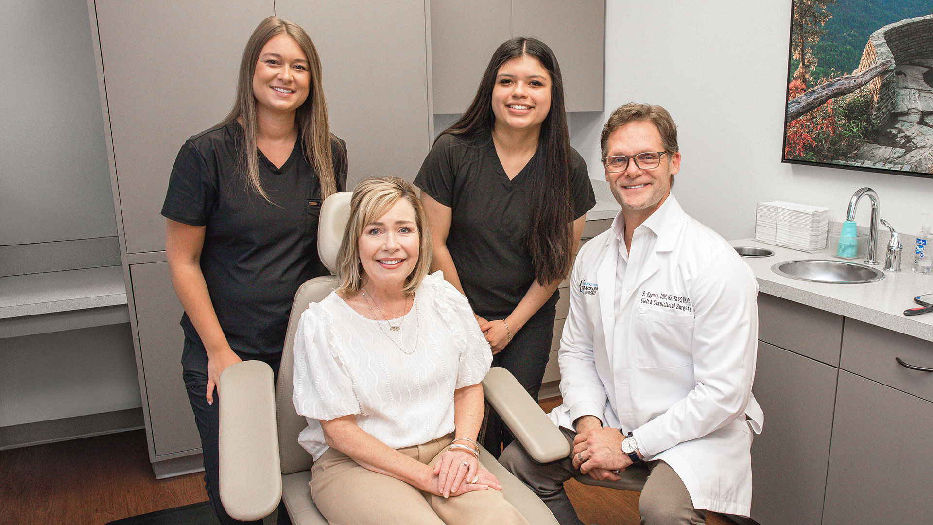 Dr. Rick Kapitan, oral surgeon in Charlotte, NC with CCOFS staff and patient