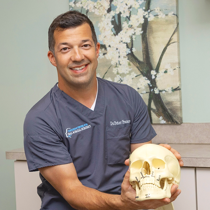 Jaw surgeon with skull model showing jaw surgery