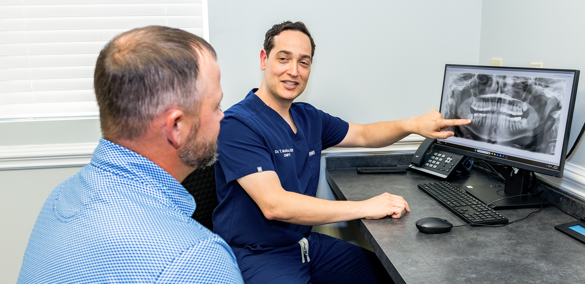 Dr. Molina explaining an x-ray to a patient